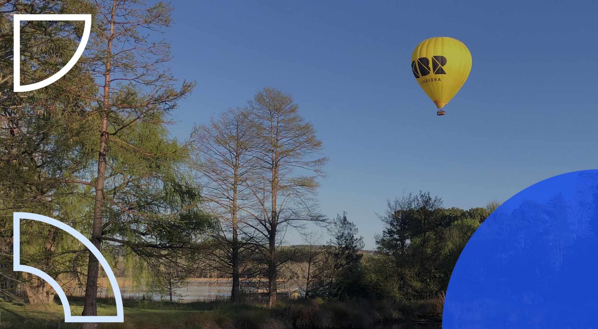 Yellow Hot air balloon rising over Lake Burley Griffin in Canberra