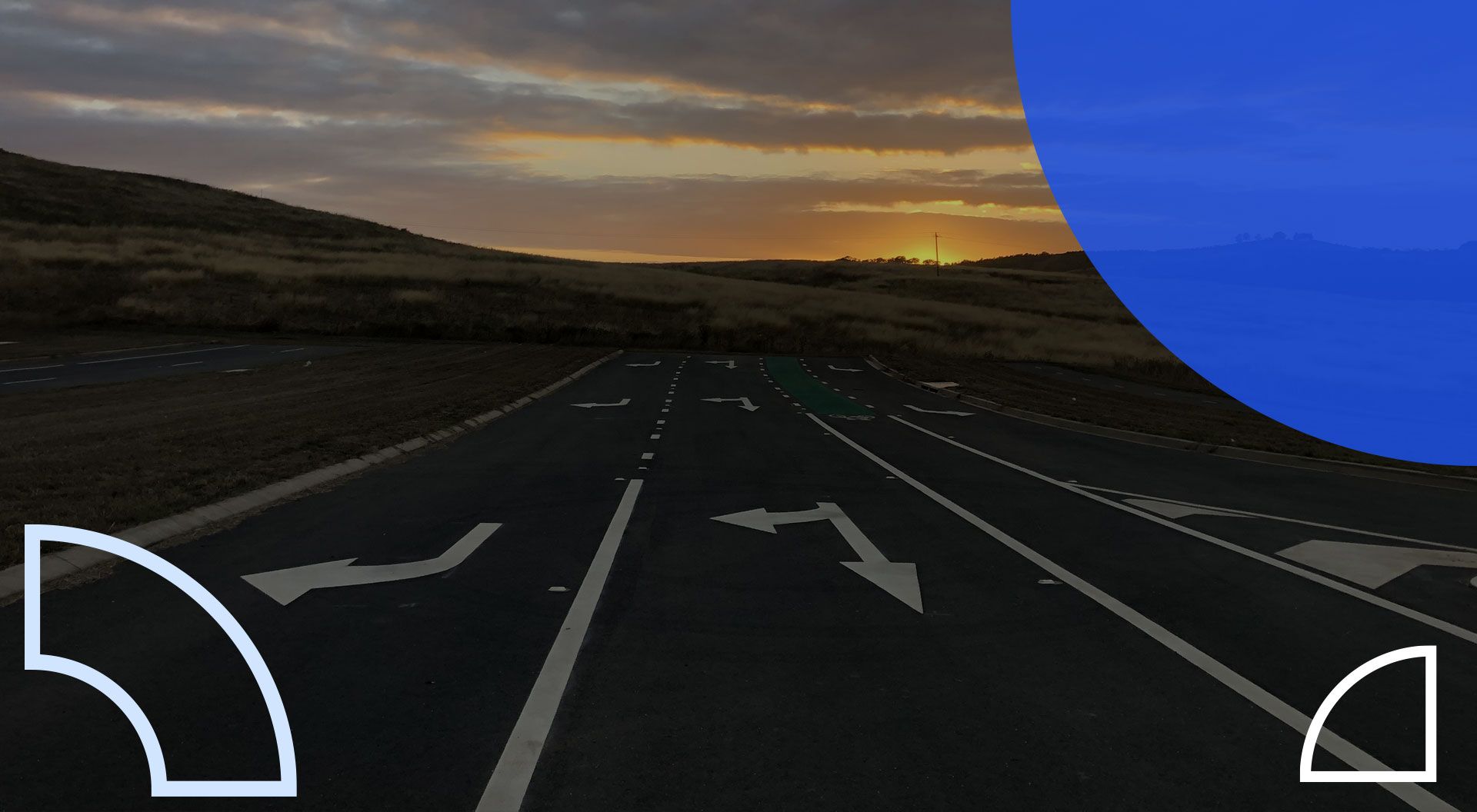 Sunrise behind 3 lanes of directional arrows on road in Canberra